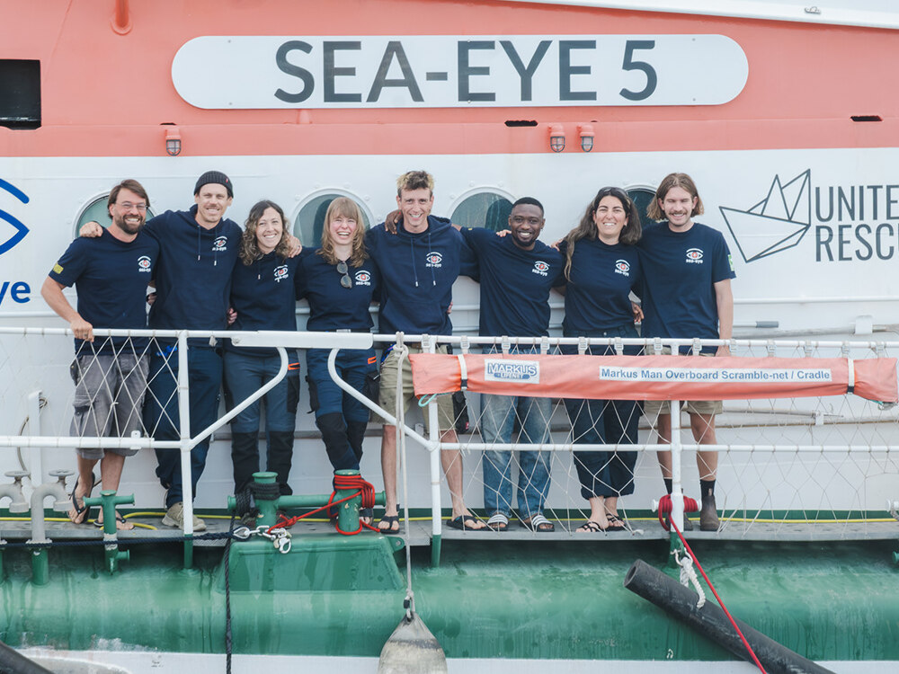 Sea-Eye Crew poses together on the deck of the SEA-EYE 5